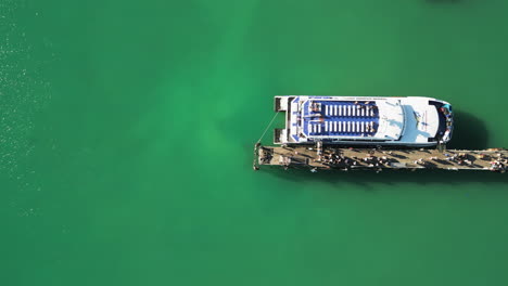 4k aerial panning over passengers boarding the lomprayah high speed ferry at pralarn pier