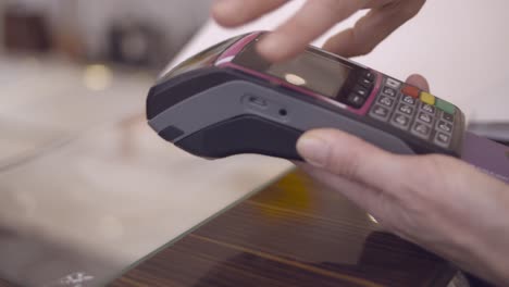 woman paying by credit card process on a store