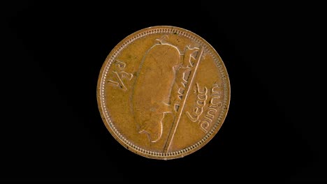 ireland 1964 halfpenny coin reverse with sow, piglets and gaelic inscription rotating on black background