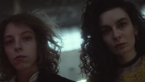 portraits of two young women with curly hair