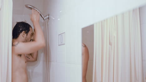 hispanic showering cold naked at bathroom at morning