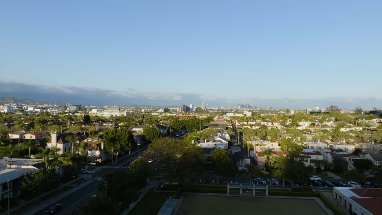 Flying up revealing the Beverly Hills community, sunrise in Los Angeles, USA - Aerial view
