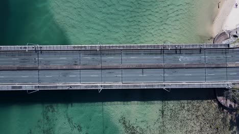 panning view of a bridge spanning tallebudgera creek allowing vehicles and pedestrians to cross the estuary