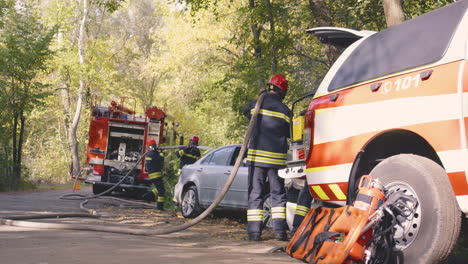 firefighters respond to a car fire in the forest