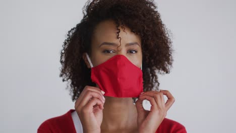 portrait of mixed race woman putting mask on