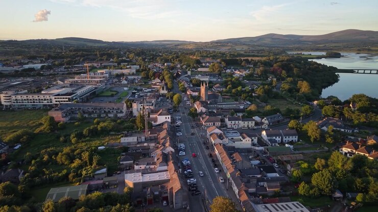 Main street in Blessington Town, golden light, aerial with Blessington Lakes landscape. Ireland