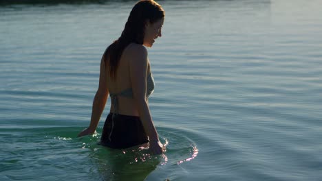 woman walking in water at beach 4k