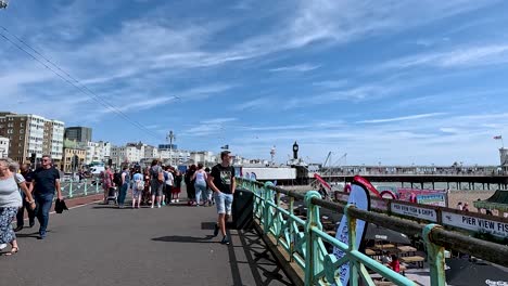 people walking on brighton pier on a sunny day