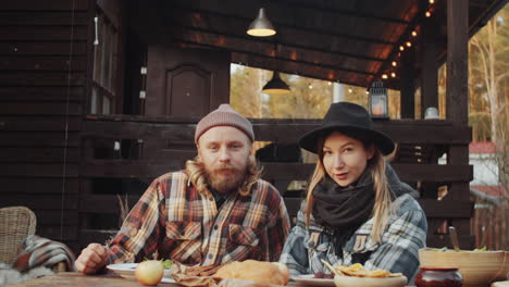 portrait of young couple at dinner table outdoors