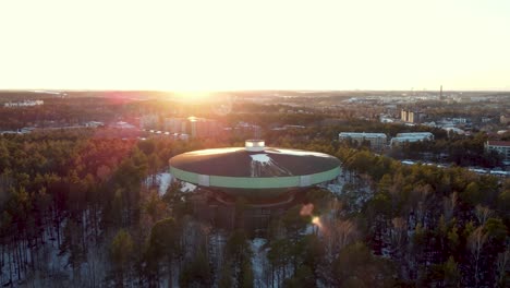 Water-tower-on-top-of-a-snowy-hill-during-the-sunset