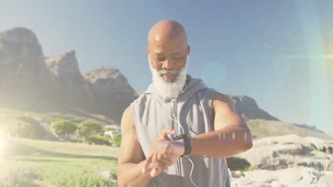 Animation-of-glowing-light-over-happy-senior-man-exercising-outdoors