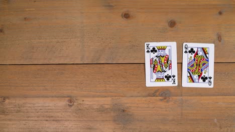 A-person-laying-out-a-royal-flush-chance-on-a-wooden-table-to-educate-the-viewer-on-how-to-play-poker