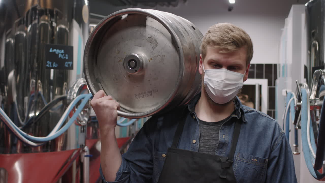 Man With Metal Barrel At Brewery