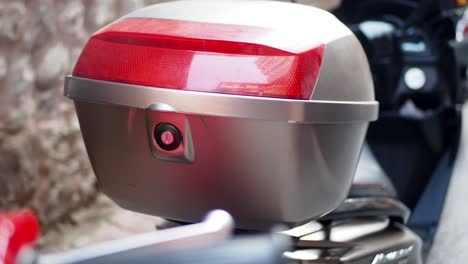 close-up of a motorcycle trunk with red light