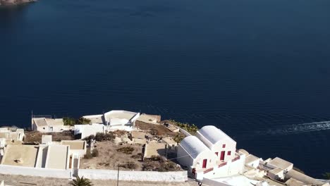 view of caldera, white houses in village thirasia in greek island santorini in greece