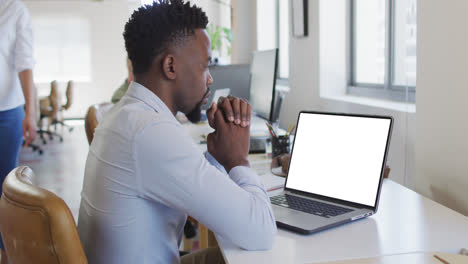 African-american-businessman-using-laptop-for-video-call-with-copy-space