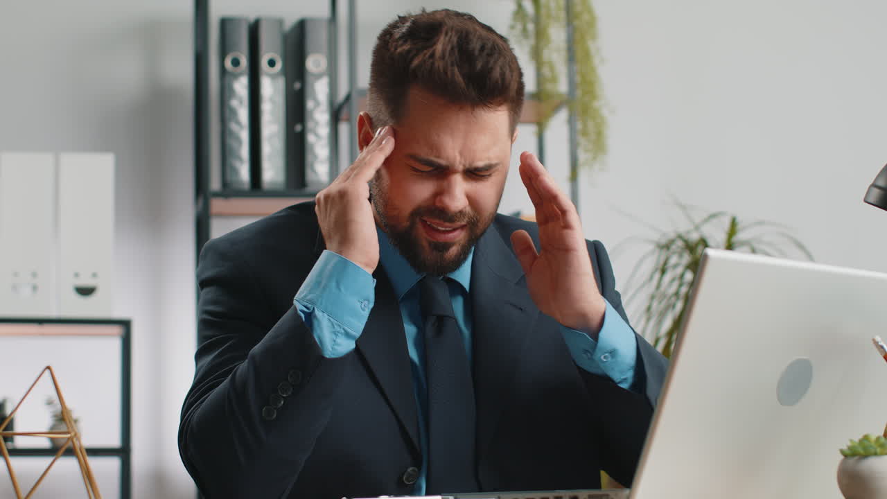 Tired caucasian business man suffering from headache problem tension migraine stress at home office