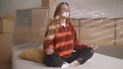 woman meditating in a new home during a move