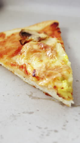 una rebanada de pizza en una caja de pizza