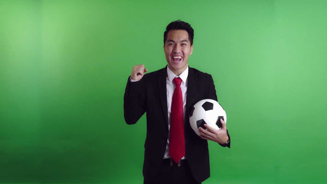 Businessman Holding A Soccer Ball And Celebrating, Video In 4K