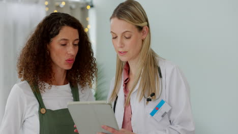 doctor consulting patient with tablet in office