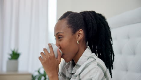 Black-woman,-thinking-and-drinking-coffee-in-bed