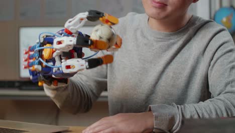 man interacting with a robotic hand