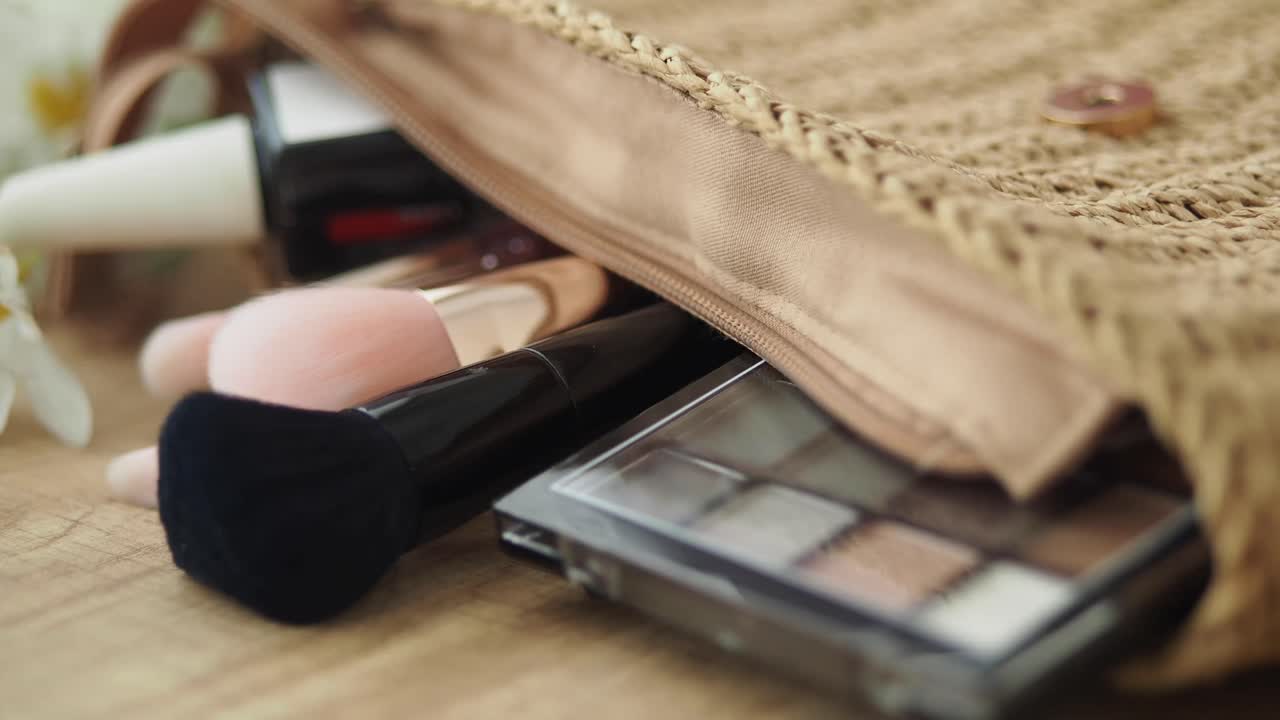 Close-up of makeup brushes and products in a cosmetic bag