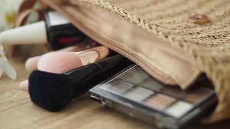 close-up of makeup brushes and products in a cosmetic bag
