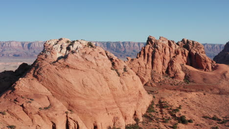 Drone-circles-around-rock-formation-revealing-valley-and-canyon