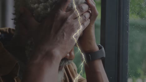 animation of lightning over sad senior african american man