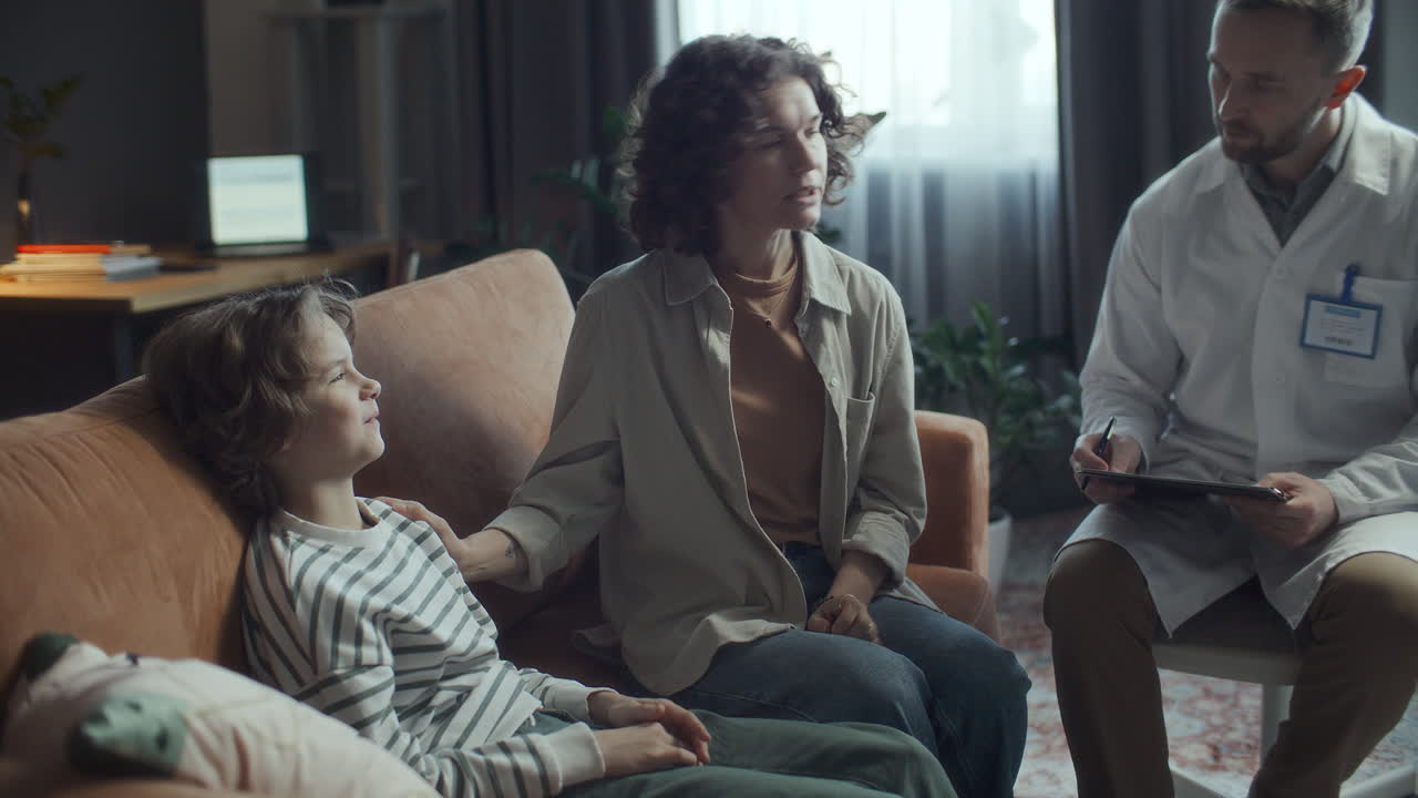 Pediatrician Talking with Mother and Child during Home Consultation