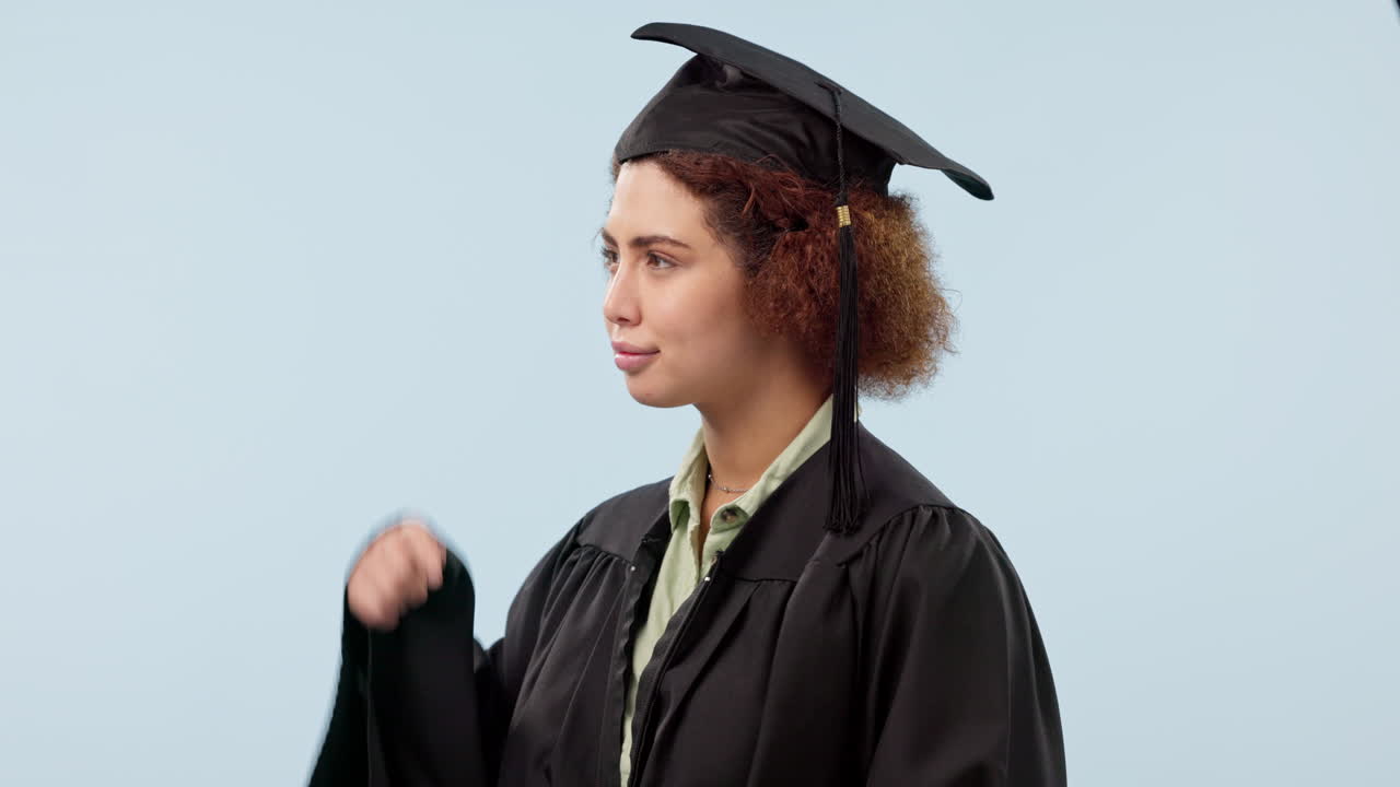 Graduation, pointing and woman in studio
