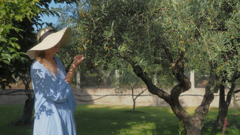 steadicam shot of woman walking and touching roses in garden