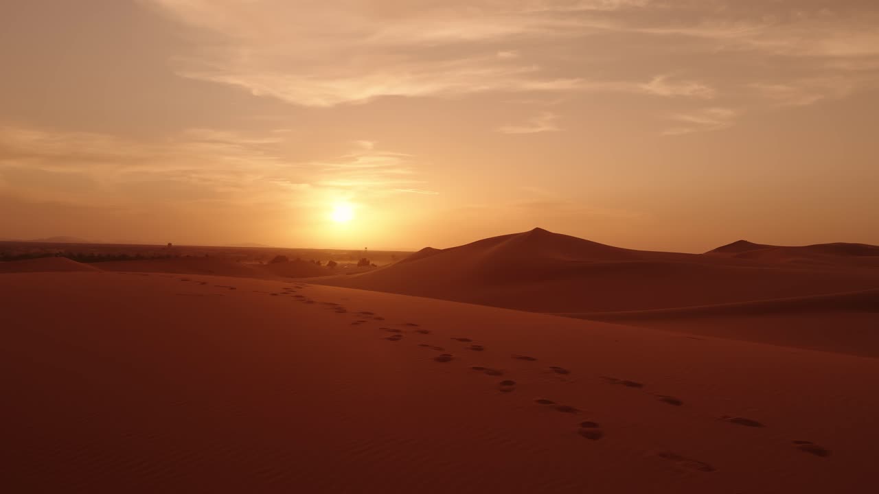 The Sahara dunes glow under a golden Moroccan sunset with soft sand textures