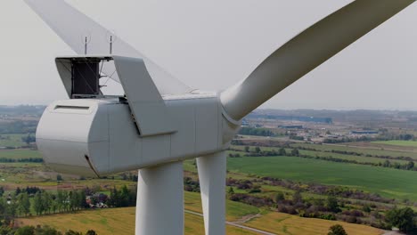 wind turbine rear view with propellers from an aerial drone panning, close up shot