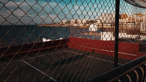 an empty basketball stadium on the coast of bugibba, malta. panning shot