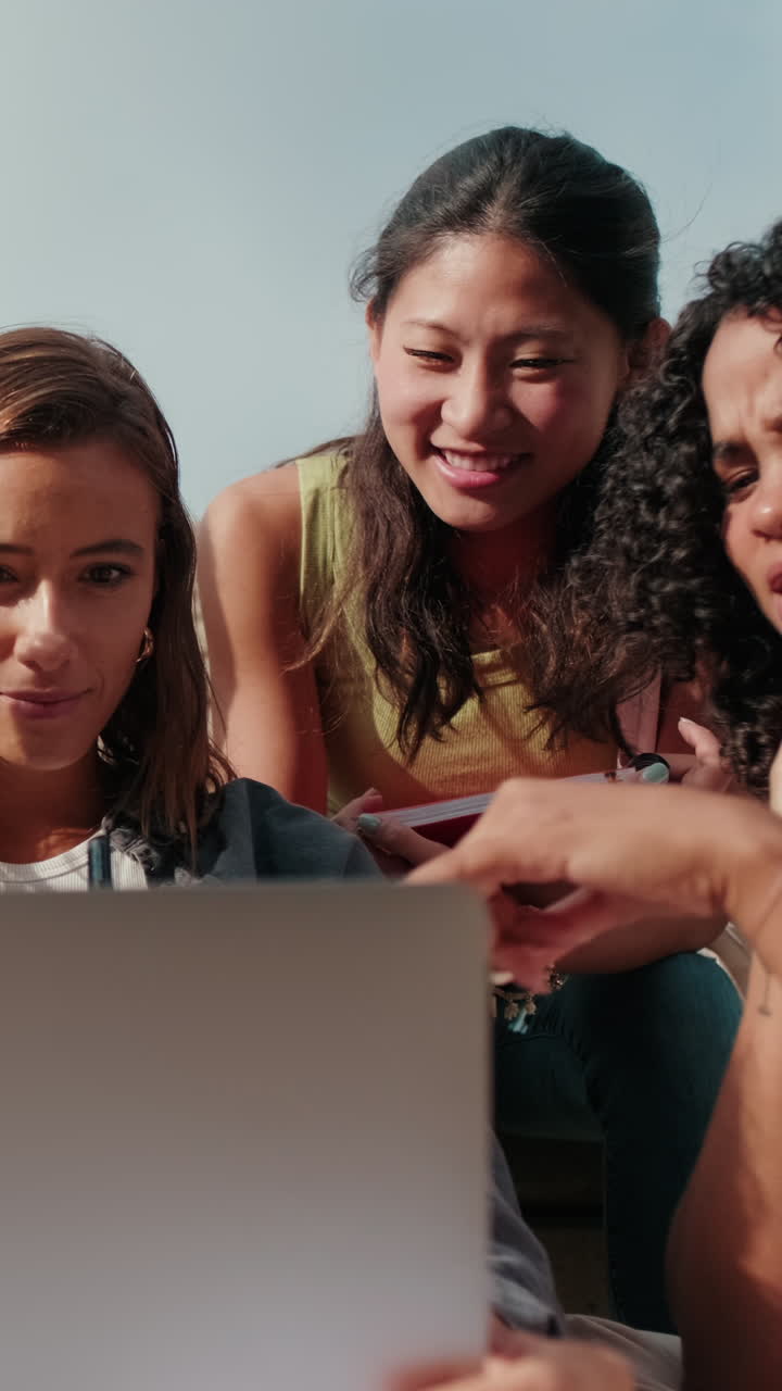 Friendly group of multiracial high-school students using computer technology