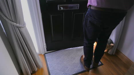 dog tries to get out front door when owner answers the dog is in hallway with owner waiting for a chance to get out