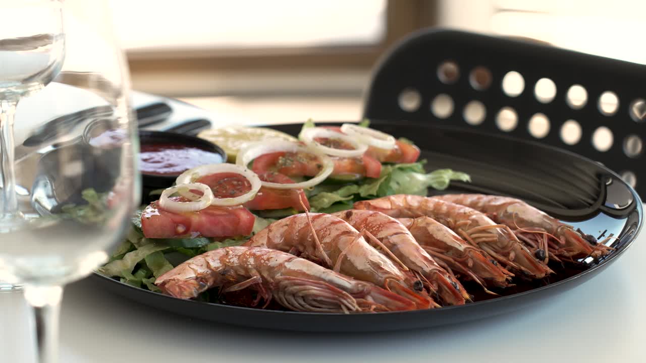 Enjoying succulent shrimp and fresh vegetables at a coastal restaurant in sunny weather - Close Up Shot