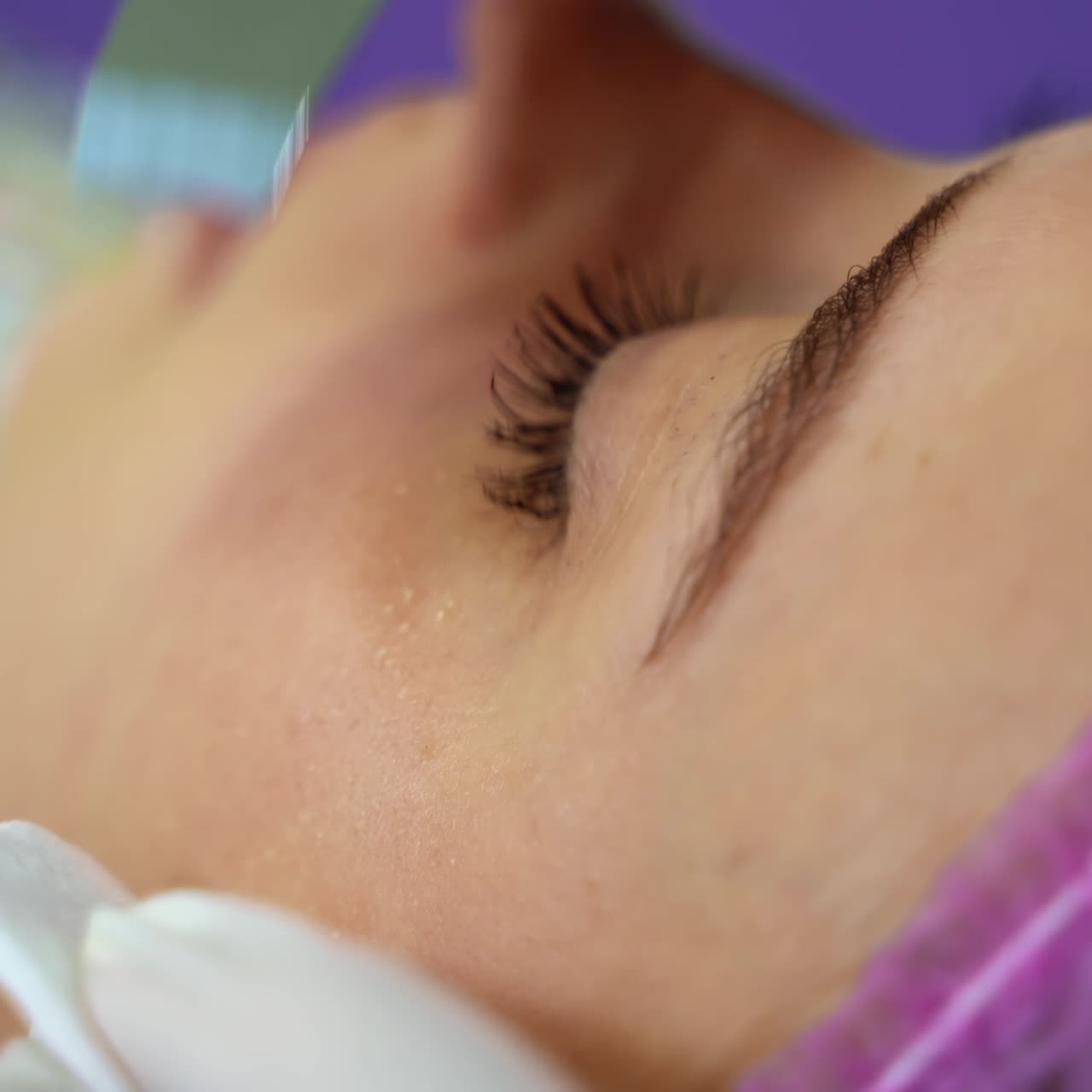 Close-up shot of cosmetician making cavitation facial peeling. Woman resting after hard working week