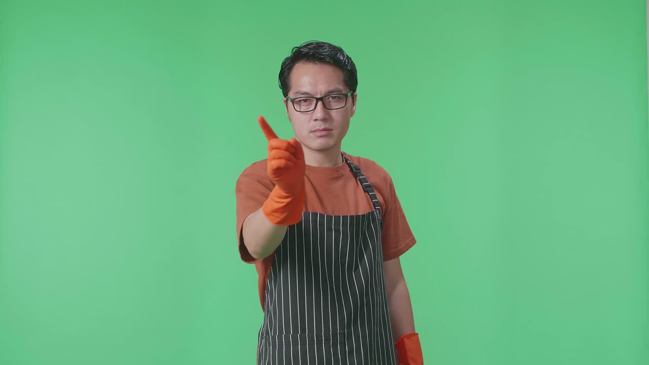 Man in Apron and Gloves Pointing