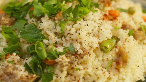 sprinkling greenery on couscous with chicken close-up. arabian cuisine. traditional middle eastern culture. delicious rice with meat. homemade food concept