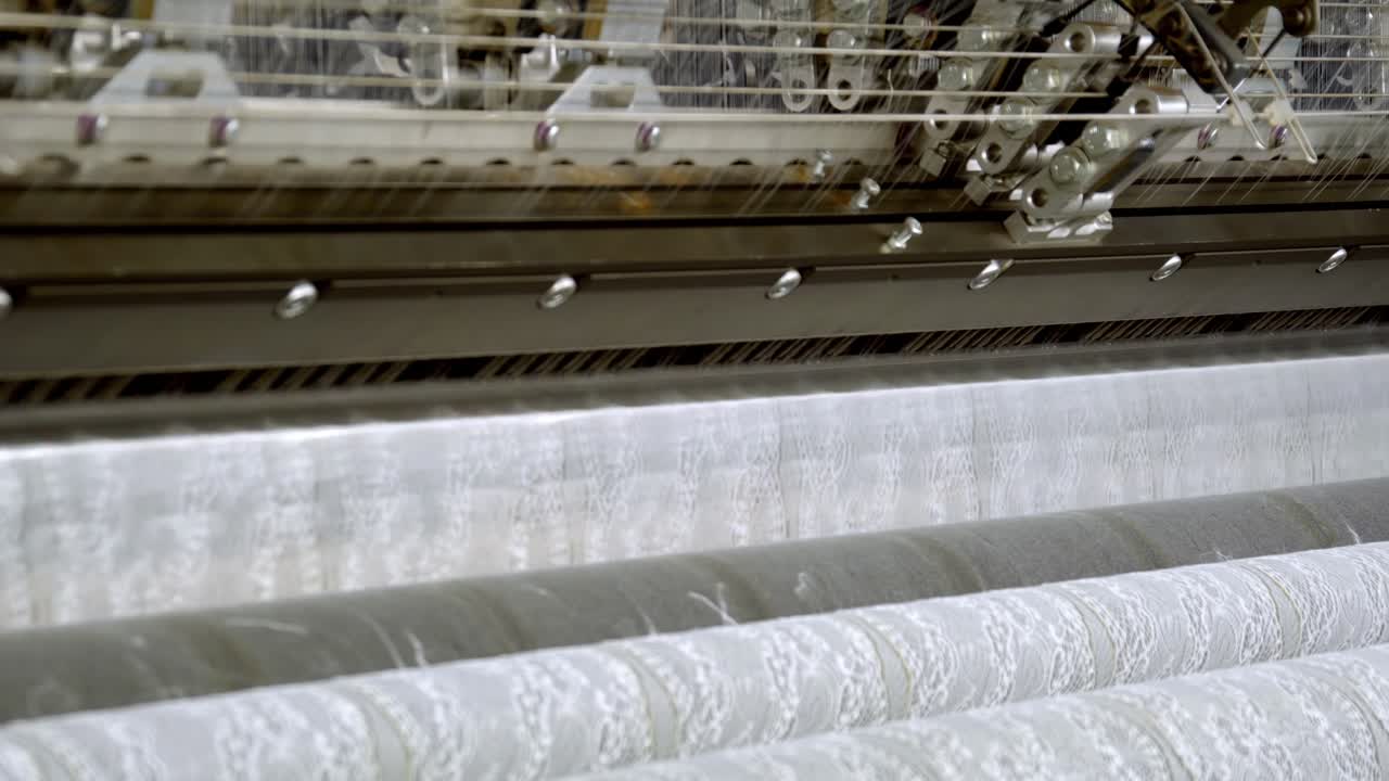 Close up of textile machinery creating industrial fabric in a factory