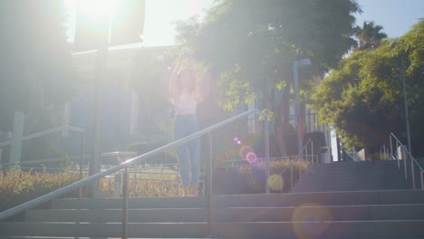 young lady standing on stairs making photo. girl taking picture on smartphone.