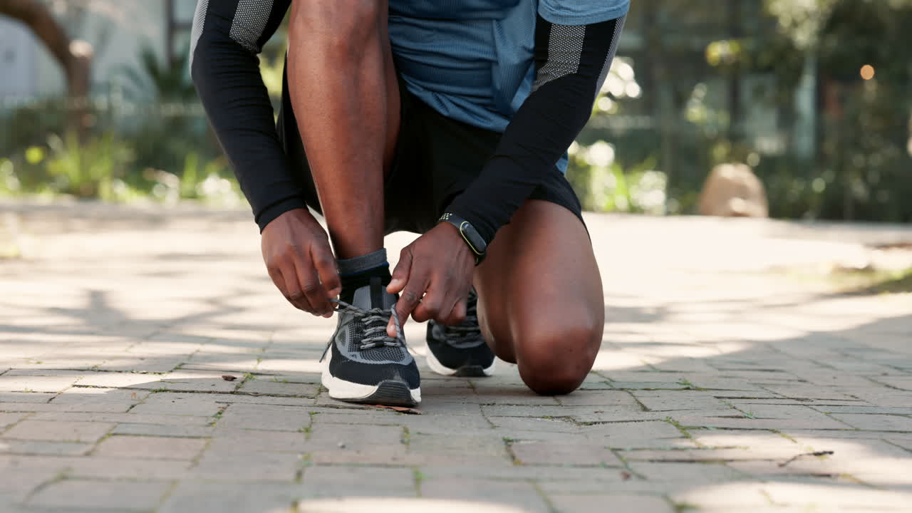 el hombre atando los cordones de los zapatos antes de ir a correr
