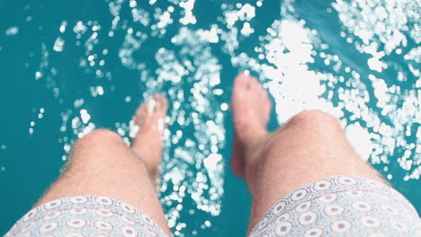 feet in sea turquoise water from boat chilling