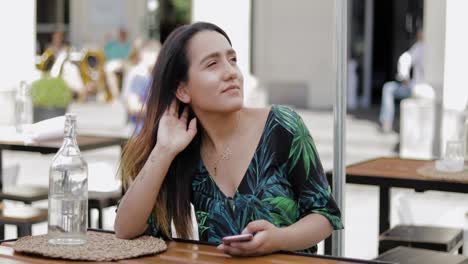 Relaxed-confident-young-woman-at-a-restaurant