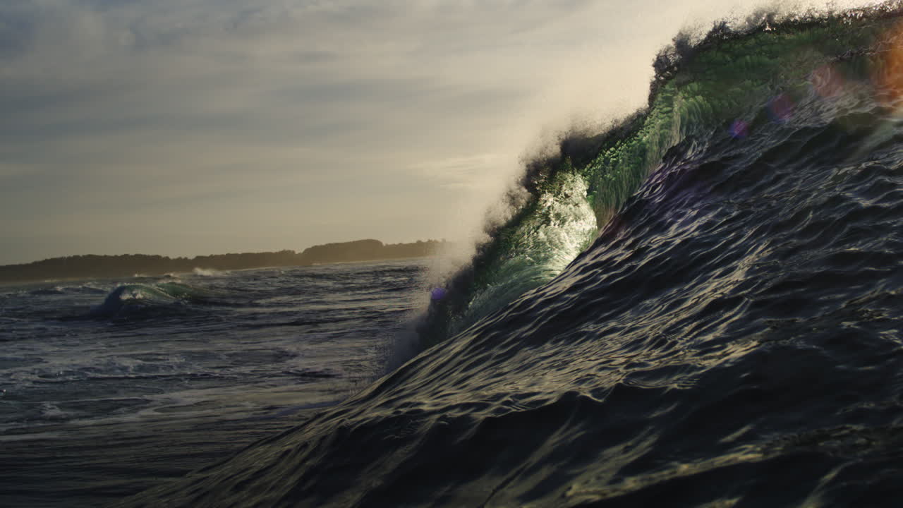 Beautiful Slow Motion Ocean Wave with Sunlight and Lens Flare