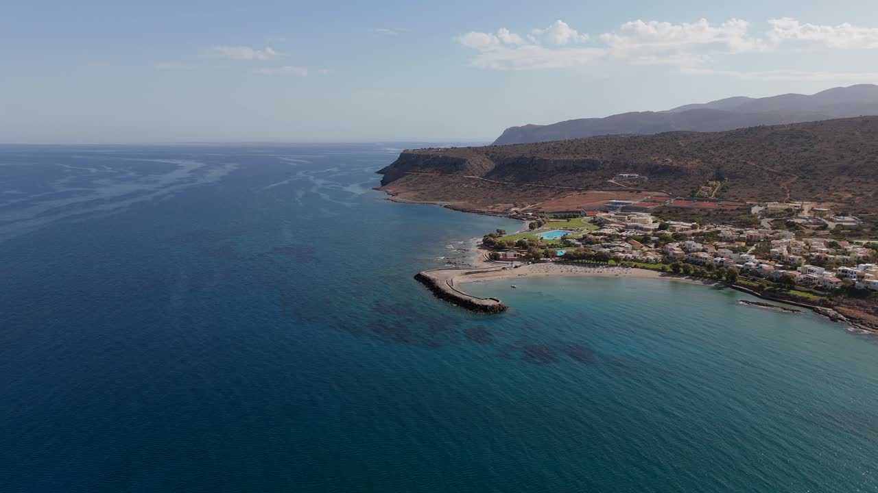 Aerial - gentle view of a serene bay with clear waters in Crete Greece